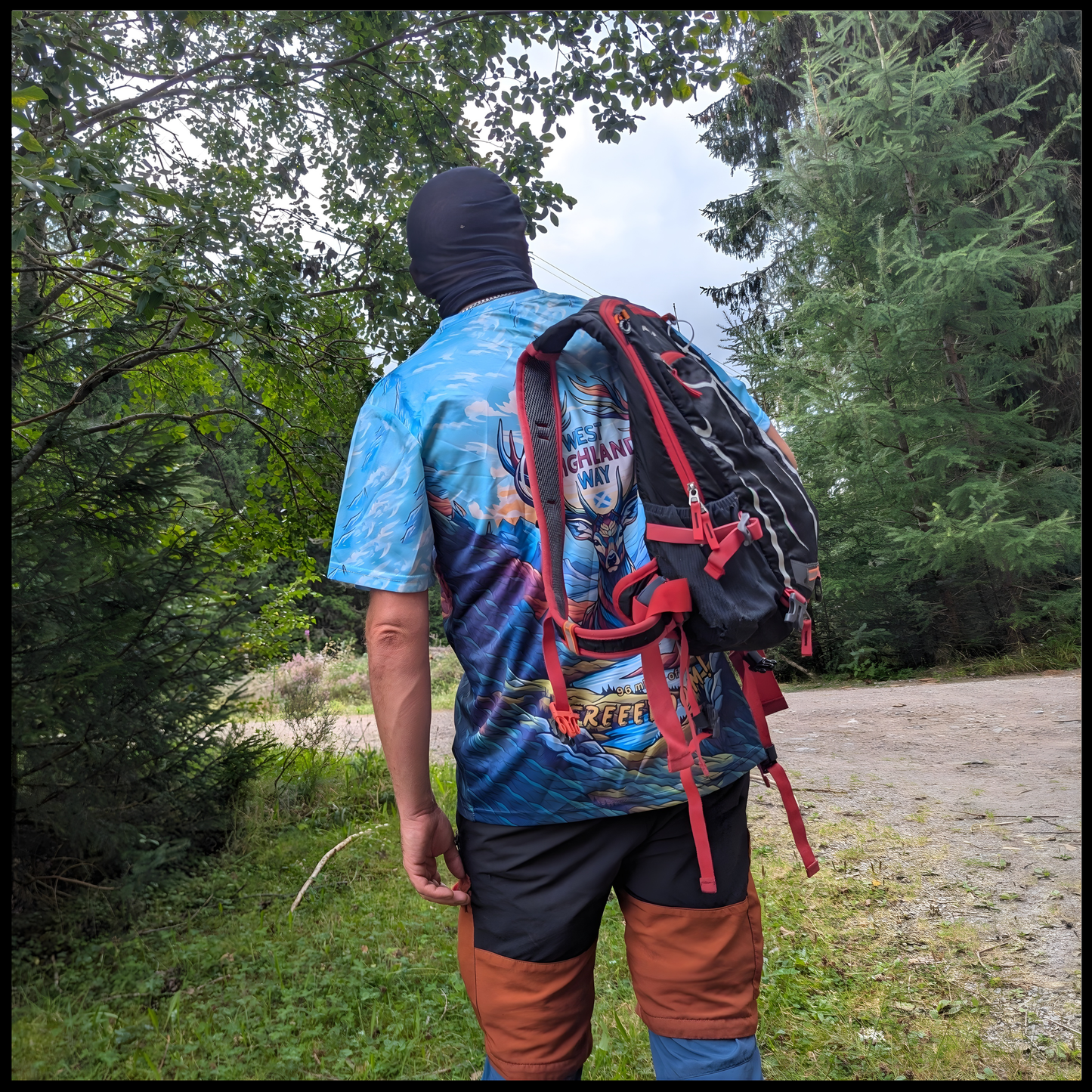Munro Mental “Stag of Bravery” t-shirt worn on West Highland Way – outdoor back view with backpack
