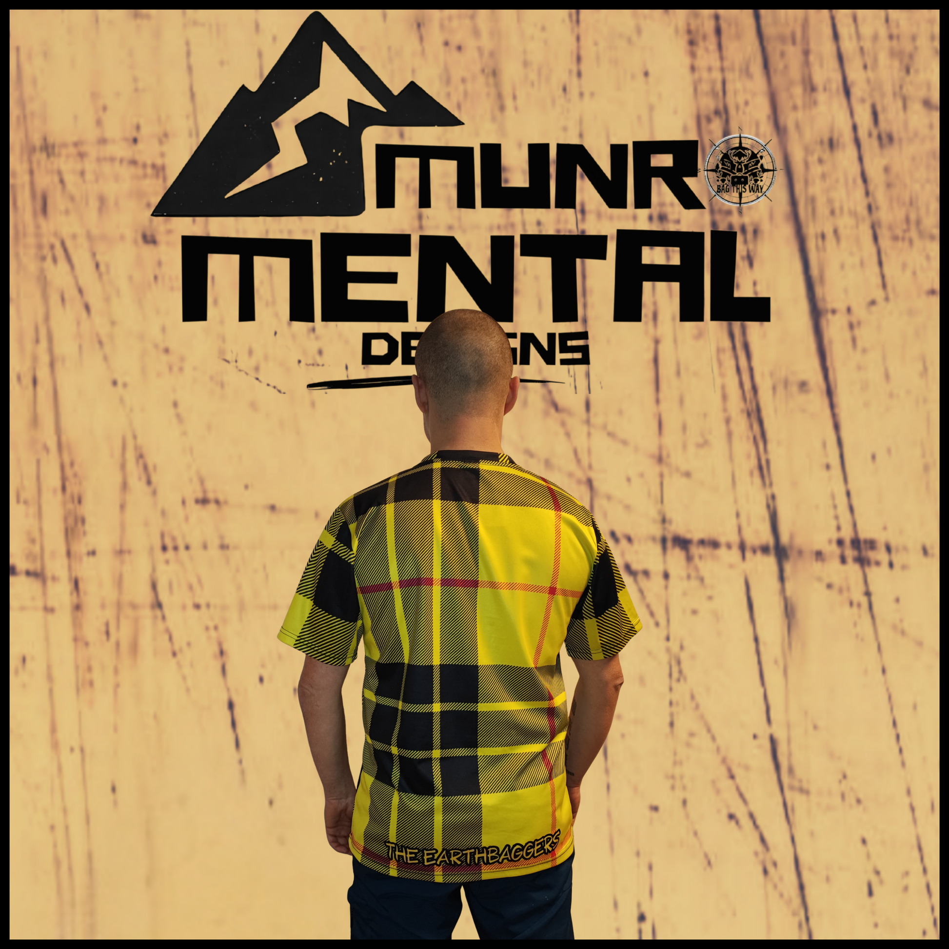 Munro Mental TShirt The Earthbaggers worn by model back view tartan pattern